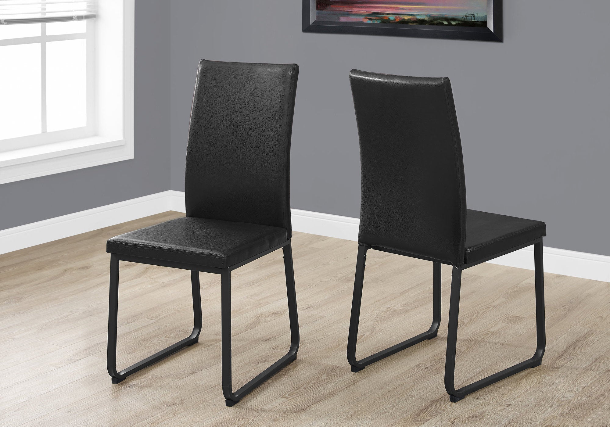 Two 38" Black Leather Look, Foam, and Metal Dining Chairs